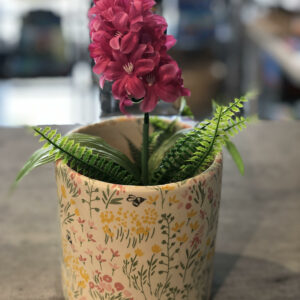 Flower pot decoupaged with spring flowers and bees